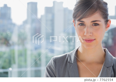 Pretty businesswoman smiling at camera Pretty businesswoman smiling at camera 7702554