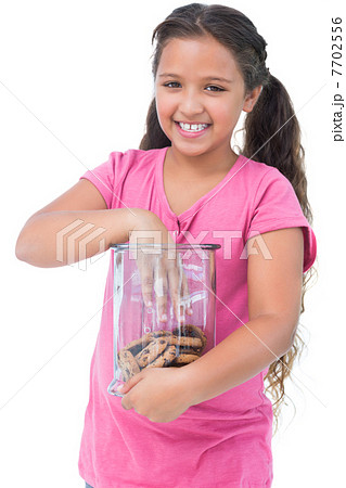 Little girl taking a cookie from jar Little girl taking a cookie from jar 7702556