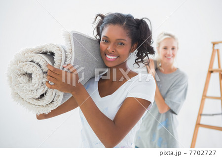 Housemates carrying rolled up rug 7702727