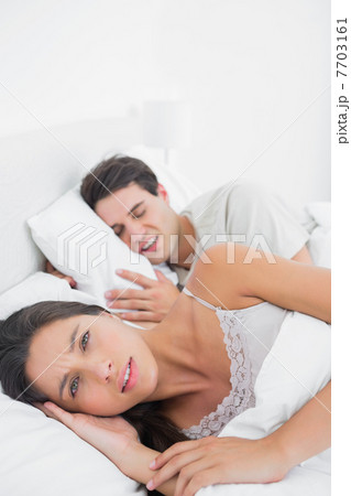 Pretty woman annoyed that her partner snoring 7703161