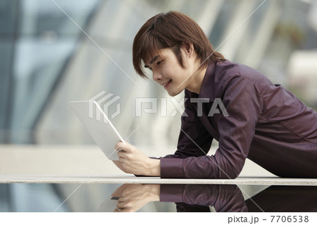 Asian Business man using a Digital Tablet 7706538