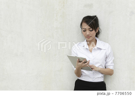 Asian Business woman using a Touch-Pad PC Asian Business woman using a Touch-Pad PC 7706550