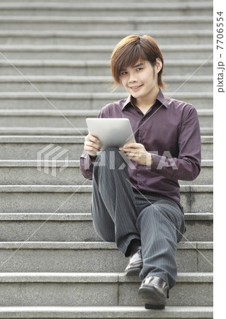 Asian Business man using a Digital Tablet 7706554