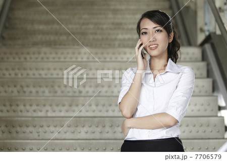 Asian Business woman using a Cell Phone Asian Business woman using a Cell Phone 7706579