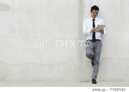 Asian Business man using a Digital Tablet 7706581