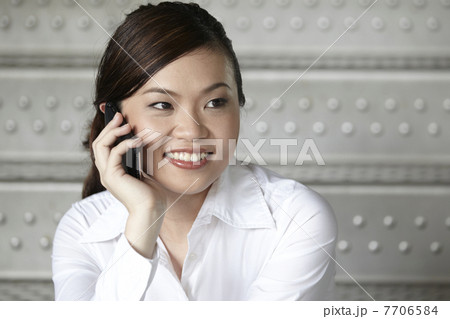 Asian Business woman using a Cell Phone 7706584