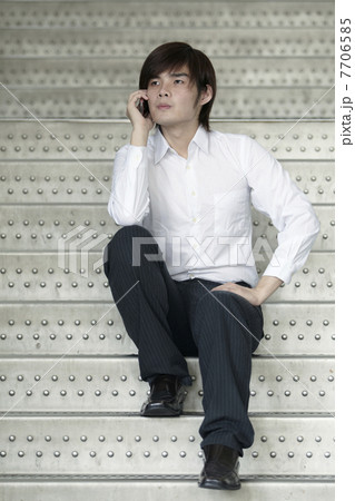 Asian Business man using a Cell Phone 7706585