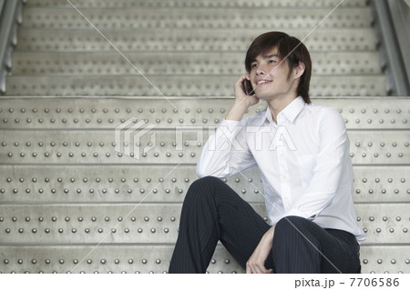 Asian Business man using a Cell Phone Asian Business man using a Cell Phone 7706586