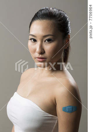 Chinese woman with Bandage on her Arm 7706964
