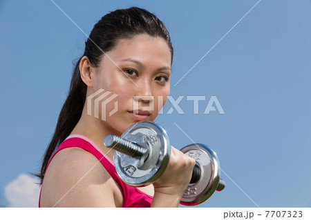 Chinese woman exercising with dumbbells Chinese woman exercising with dumbbells 7707323