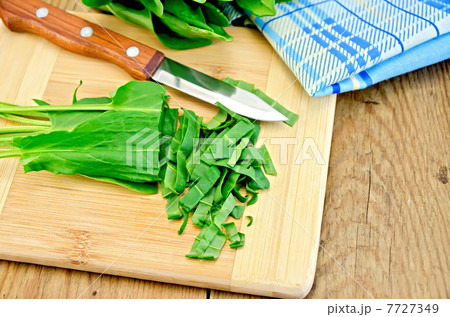 Sorrel cut on a board with a knife and napkin 7727349