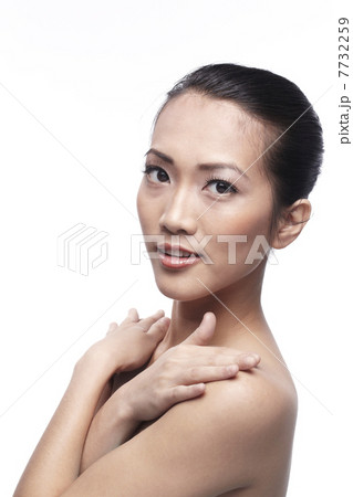 Beautiful Asian woman gently touching her face. Beautiful Asian woman gently touching her face. 7732259