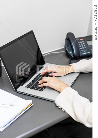 Hands typing on laptop keyboard 7732853