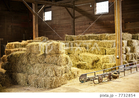 Interior of barn with hay bales 7732854