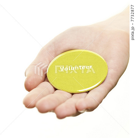 Hand holding volunteer button 7732877