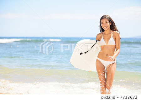 Surfer girl - body surfing beach woman laughing 7733672