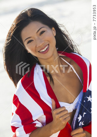 Beautiful Asian Woman Girl in American Flag on Beach 7733953