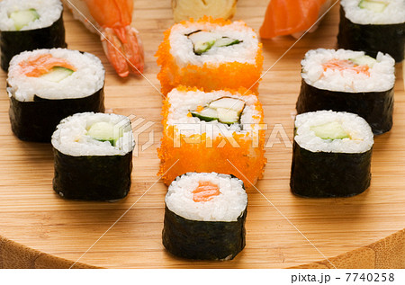 Different types of sushi on a bamboo plate Different types of sushi on a bamboo plate 7740258