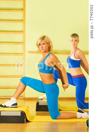 Beautiful women exercising in fitness club 7740302