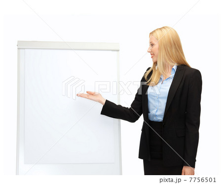 businesswoman pointing at white blank flipchart businesswoman pointing at white blank flipchart 7756501