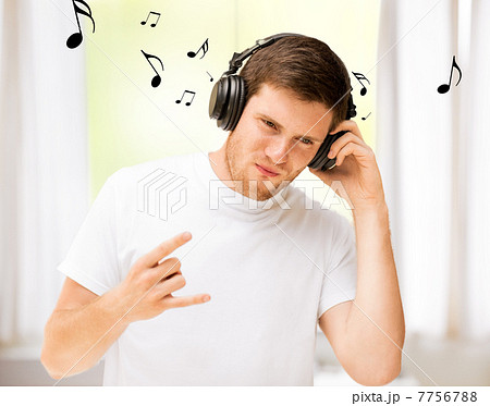 man with headphones listening rock music at home man with headphones listening rock music at home 7756788