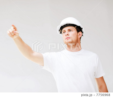 male architect looking at blueprint male architect looking at blueprint 7756968
