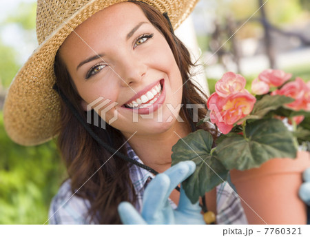 Young Adult Woman Wearing Hat Gardening Outdoors 7760321