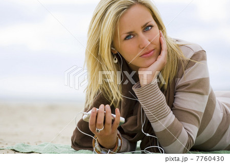 Woman Girl Listening to MP3 Player on Beach 7760430