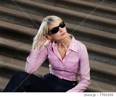 Beautiful young woman sitting on a stairs Beautiful young woman sitting on a stairs 7765269