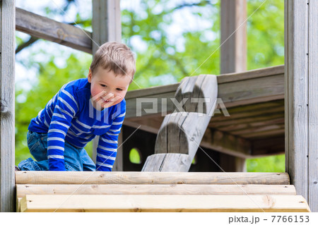 Little Kid on a jungle gym Little Kid on a jungle gym 7766153