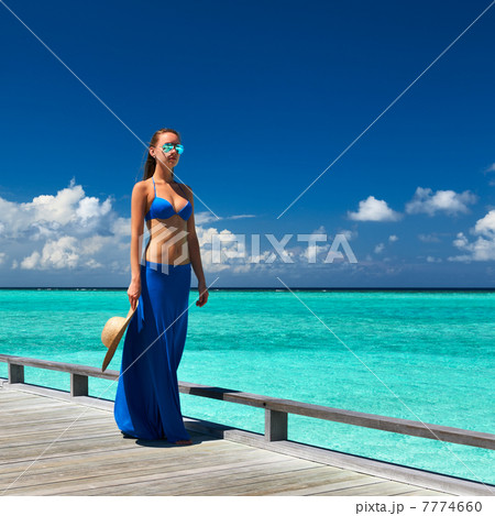 Woman on a beach jetty at Maldives 7774660