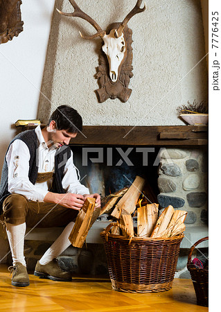 Young man in a hunter's cabin or alpine hut Young man in a hunter's cabin or alpine hut 7776425