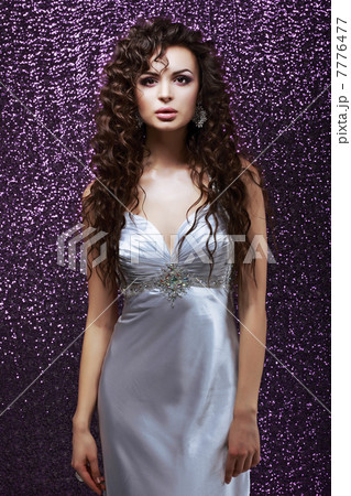 Sophistication. Glamor. Sensual Brunette with Waved Hairs and Silk Blue Dress Sophistication. Glamor. Sensual Brunette with Waved Hairs and Silk Blue Dress 7776477