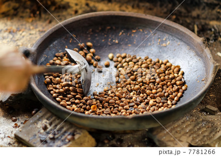 Coffee beans are roasting in pan. Traditional techniques 7781266
