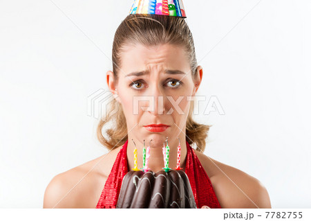 Woman celebrating birthday with cake candles wiped 7782755