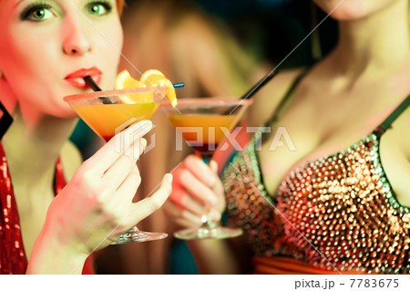 Women in club or disco with cocktails 7783675