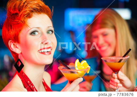 People in club or bar drinking cocktails 7783676