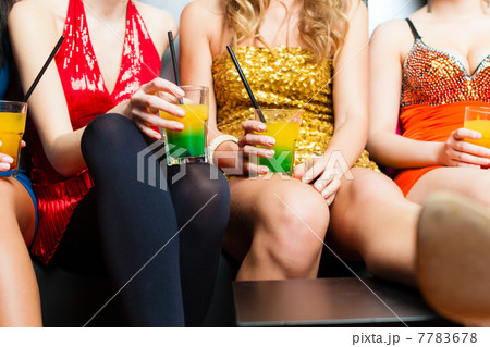 Women in club or disco drinking cocktails 7783678