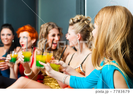Women in club or disco drinking cocktails 7783679