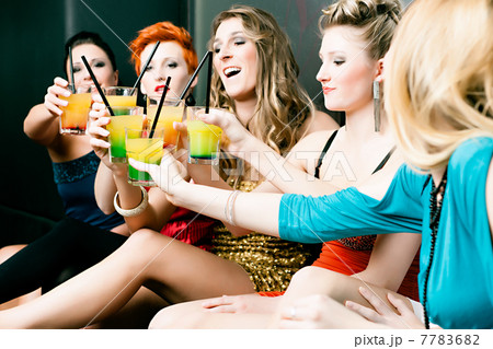 Women in club or disco drinking cocktails 7783682