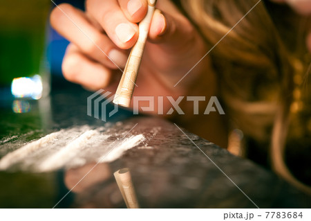 Young woman snorting cocaine 7783684