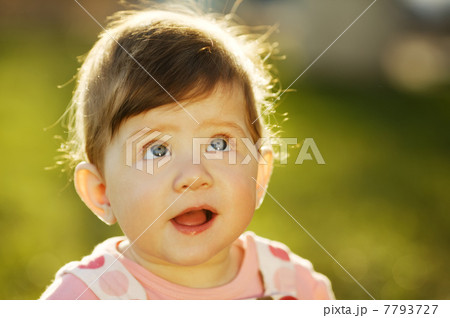 baby sitting on grass in garden 7793727