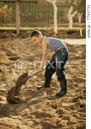 little boy working with shovel in garden little boy working with shovel in garden 7793731