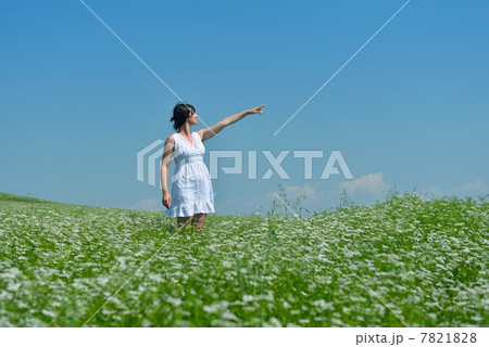 Young happy woman in green field 7821828