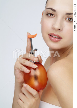 Young woman holding a small watering can Young woman holding a small watering can 7826351