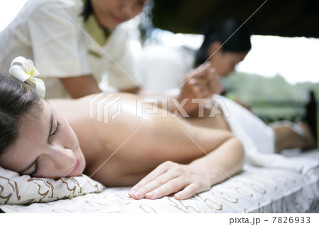 Woman receiving back massage Woman receiving back massage 7826933