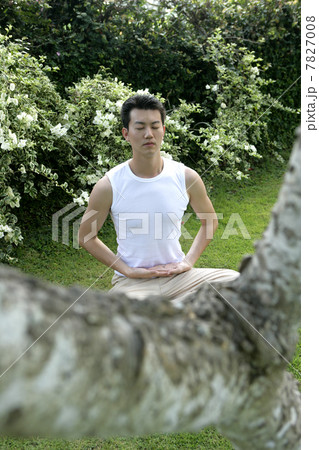 Young man practising Qigong Young man practising Qigong 7827008