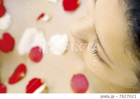 High angle view of young woman having flower shower High angle view of young woman having flower shower 7827021