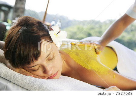 Womon lying on massage table outdoors Womon lying on massage table outdoors 7827038