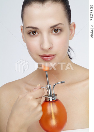 Young woman holding a small watering can 7827359